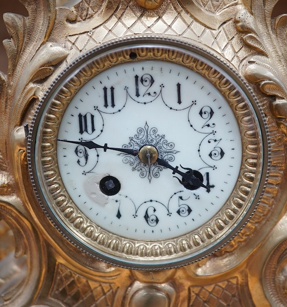 A late 19th century gilt bronze rococo style mantel clock, with pendulum, 38cm tall. Condition - fair, not tested